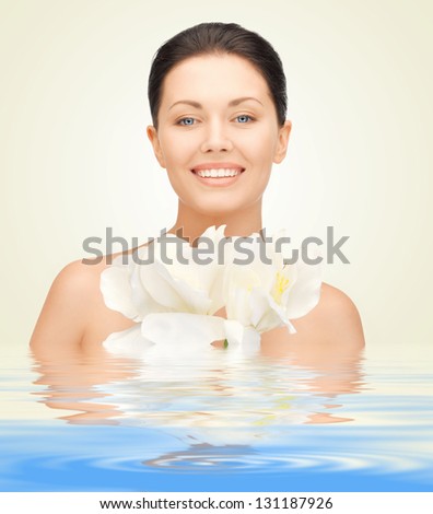 picture of lovely woman with orchid flower in water