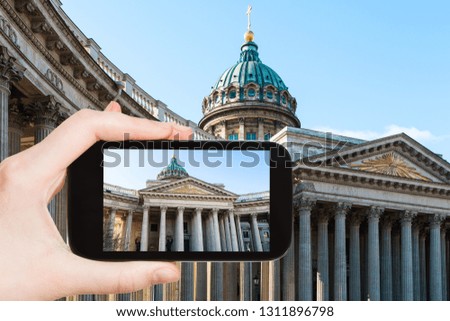 travel concept - tourist photographs of Kazan Cathedral in Saint Petersburg city in Russia on smartphone