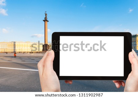 travel concept - tourist photographs of Palace Square with Alexander Column in Saint Petersburg city in March on smartphone with empty cutout screen with blank place for advertising
