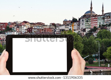 travel concept - tourist photographs of Fatih district in Istanbul city in Turkey in spring evening on smartphone with empty cutout screen with blank place for advertising