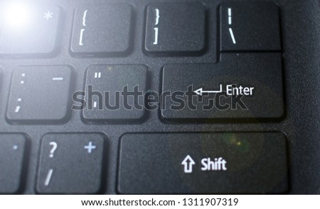 Enter button on laptop keyboard. Close up of Enter key of Laptop computer.  Enter keyboard key button on a computer with light effect. 
