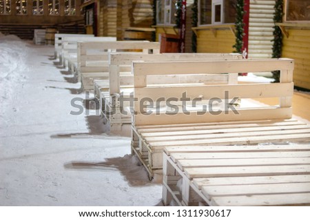 Benches made of wooden pallets in the snow