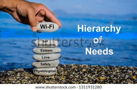 Wi-fi, internet, mobile smartphone addiction concept. Man adding stone to pebble tower.