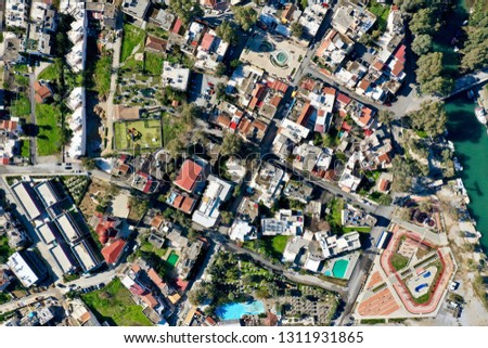 The downtown Georgioupoli, Crete, Greece by aerial photography, fountain on the main place plus the surrounding houses from various altitudes