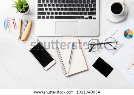 Stylized clean marble office working desk with smartphone, laptop, glasses and coffee, workspace design, mock up, top view, flat lay, copy space, closeup