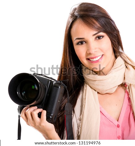Female photographer holding a camera and smiling - isolated over white