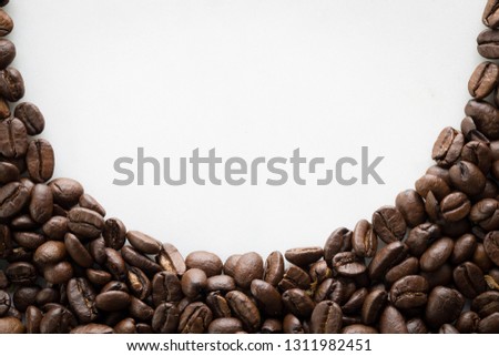 Coffee beans arranged in arch with text copy space in centre on a white background