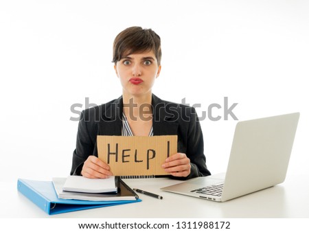 Tired and frustrated young attractive business woman working on computer holding desperate a help sign at office isolated on white background. Coping with Stress and frustration at work concept.