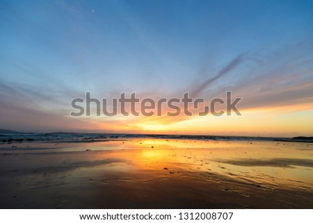 Sunset sky and sandy coast and sea