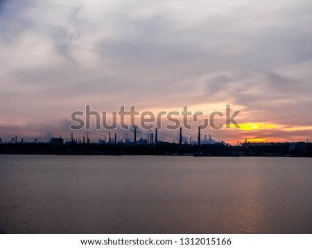 Sunset over the river and panoramic industrial lanscape.