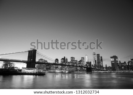 New York, United States of America - November 18, 2016: Skyline of Lower Manhattan with Brooklyn Bridge at sunset.
