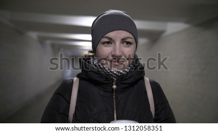 smiling woman in a tunnel in winter