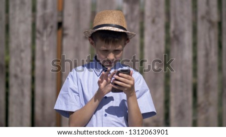 Boy in the hat uses the phone