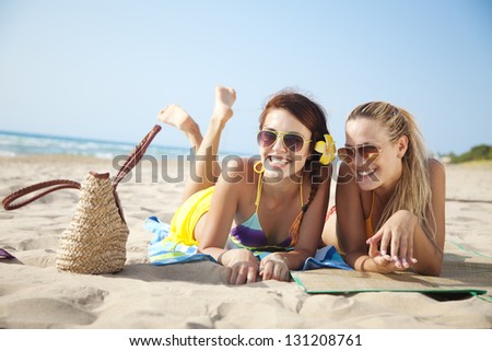 two female friends having fun on the beach