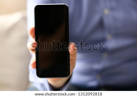 Businessman arm expose monitor of cellphone to camera closeup. Stock market trade and investment database data search strategy wifi communication wireless inspiration idea web surf network message