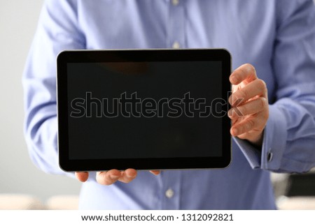Businessman arm expose blank monitor of pc pad to camera closeup. Stock market trade and investment database data search strategy wifi communication wireless inspiration idea web surf network message