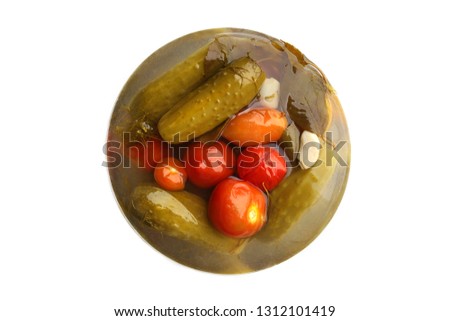 Preserved vegetables tomato and cucumber isolated on white background. Abstract pickled vegetables picture top view.
