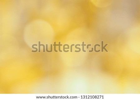 Abstract blurred focus of beautiful round bokeh lights in warm golden tone for glossy background and festive decoration. Seasons greetings and celebrations concept