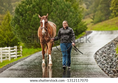 Young horse trainer exercising her horse.