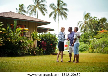 Real estate agent greeting her clients. Royalty-Free Stock Photo #1312120652