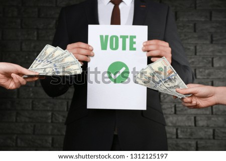 Man selling his vote on dark background. Corruption concept