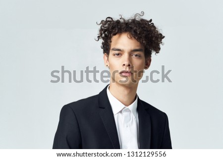 Cute guy in a suit on a gray background office worker