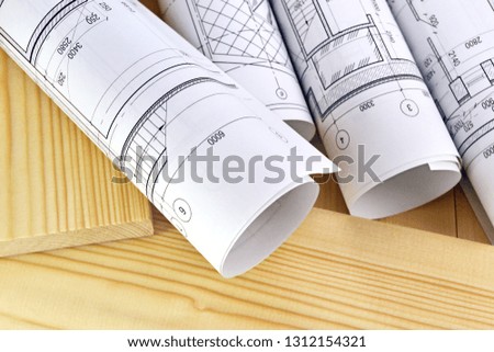 Photo of several drawings for the project engineer jobs and wooden boards