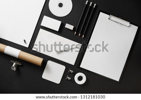 Blank corporate stationery set on black paper background. Branding mock up. Flat lay.