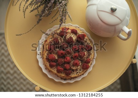 Puncake with hot tea and berries on a metal table. Artistic film photography like picture.