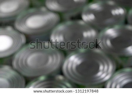 Blurred. Round caps. Abstract background of cans