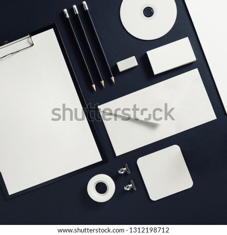Photo of blank stationery template on black paper background. Responsive design mock up. Flat lay.