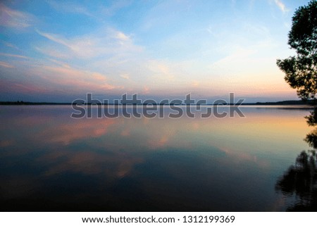 
Beautiful landscape of pink sunset on the background of the lake. sunset reflection in water
