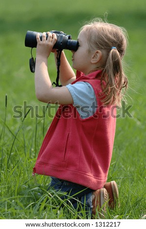 Little girl on a meadow - looking for birds