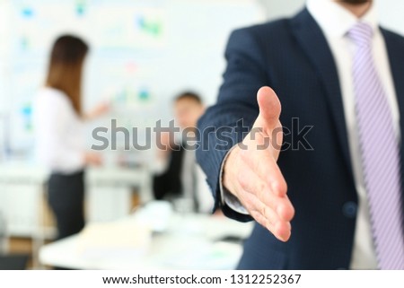 Hand handsome cheerful man offer hand as hello in office portrait. Serious excellent prospect friendly support service introduction or thanks gesture gratitude invite to participate concept