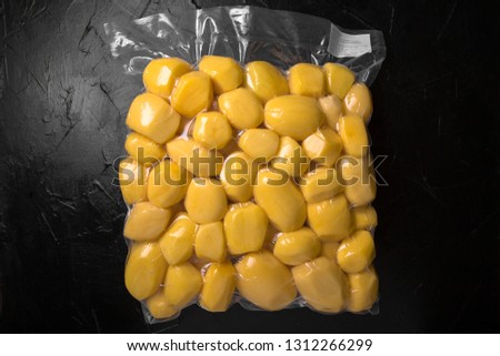 Prepack Vegetables Ingredients. Fresh raw whole potato tubers, peeled, ready to cooking package blowing (bagginess) in vacuum packaged. Royalty-Free Stock Photo #1312266299