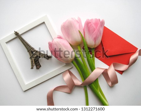 Romantic concept.  Eiffel tower figurine, flowers and envelope. congratulation. invitation. postcard layout. mockups