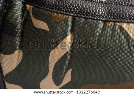 Camouflage texture fabric close-up abstract background.