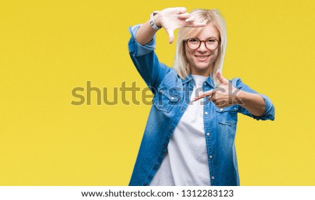 Young beautiful blonde woman wearing glasses over isolated background smiling making frame with hands and fingers with happy face. Creativity and photography concept.