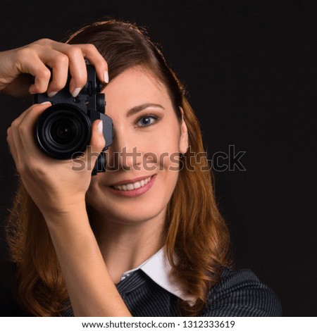 Young woman holding a camera. 