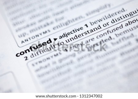 Blurred close up to the dictionary definition of Confused