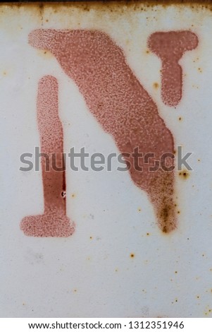 letter N painted on grungy surface, isolated, red letter, white background