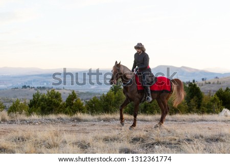 young man is riding a horse at sunset, Seljuk and Ottoman soldier riding horse