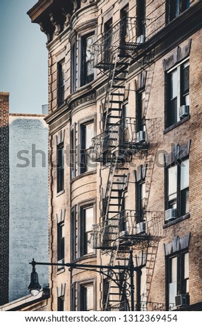 New York old building with fire escapes, color toned picture, USA.