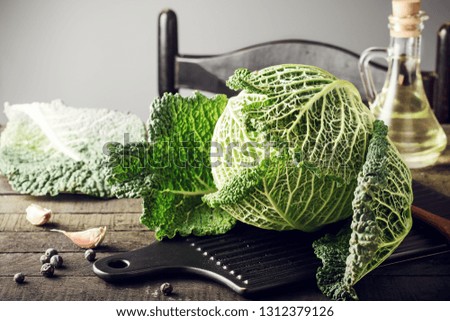 Fresh savoy cabbage on wooden table.