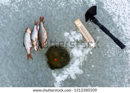 Ice hole fishing. Winter fishing in freezing cold weather concept