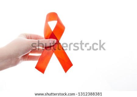 red ribbon in the hands of a girl