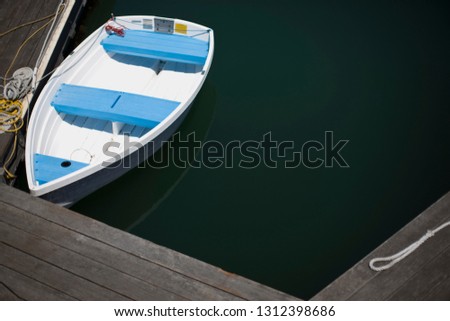 Small dinghy tied to a jetty.