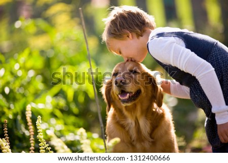 Girl kissing dog on the head
