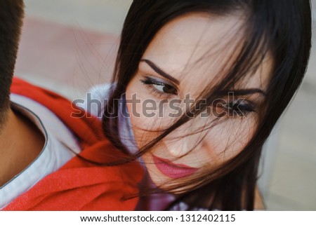 Portrait of a beautiful girl with hair in her eye.