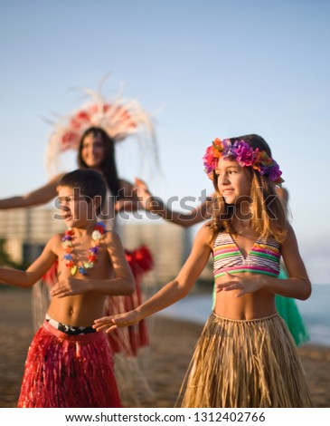 Brother and sister hula dancing.